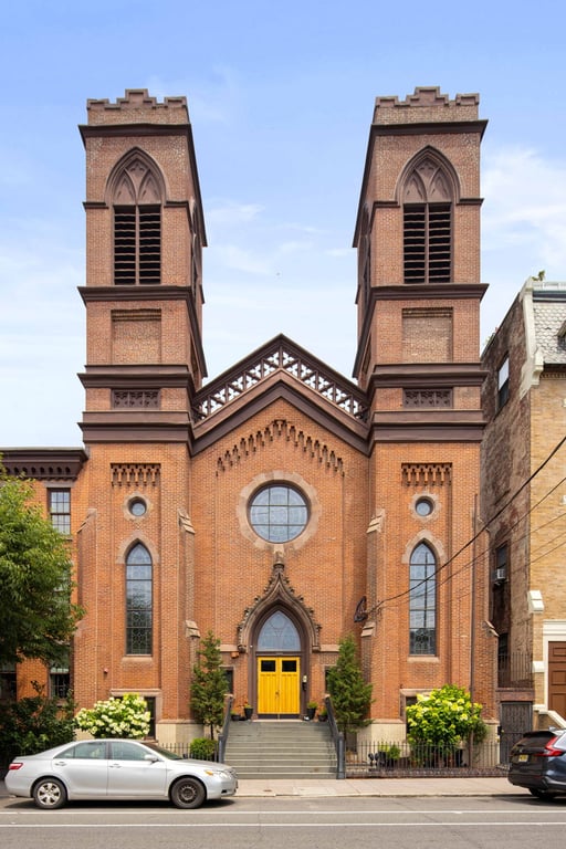 Twin towers and brick facade of Boniface Lofts at 260 First Street in Jersey City