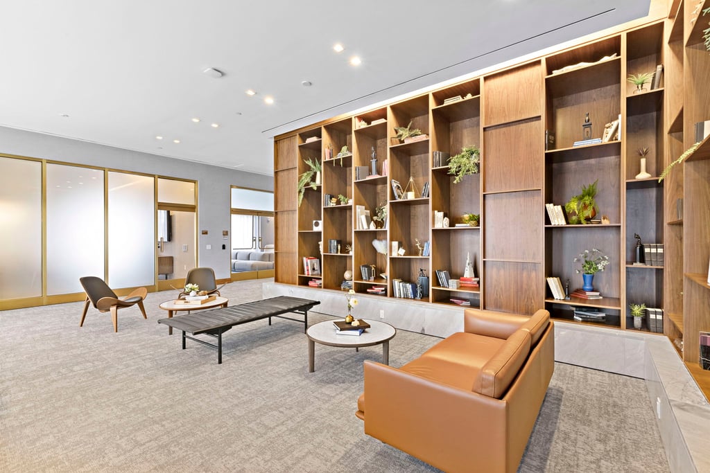Resident lounge with wood shelving and seating at 75 Park Lane South, Jersey City