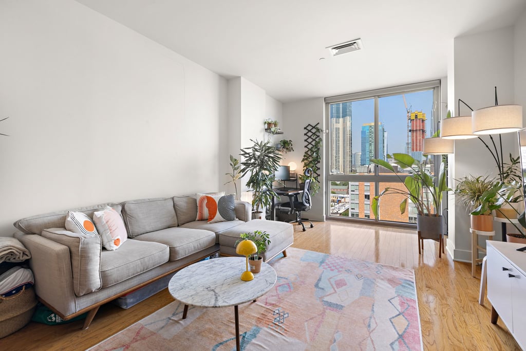 Living room with large windows at a Gulls Cove residence, 201 Marin Boulevard in Jersey City