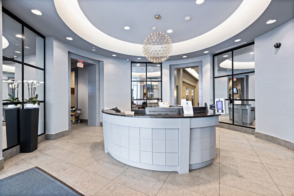 Curved reception desk and glass partitions in a Gulls Cove lobby in Jersey City