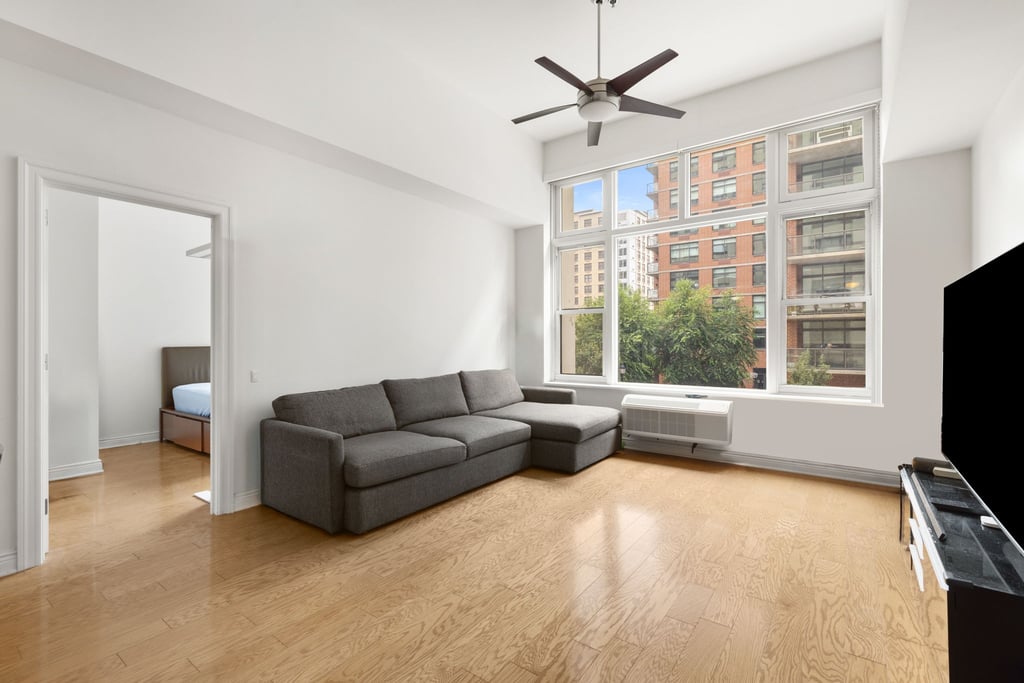 Hudson Tea Building Guide: Uptown Hoboken Loft Condos 2 Living room with tall windows and high ceilings at Hudson Tea, 1500 Hudson Street residence 2M