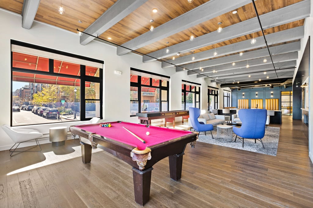 Hudson Tea Building Guide: Uptown Hoboken Loft Condos 3 Hudson Tea resident lounge with billiard table, exposed ceiling beams and tall windows